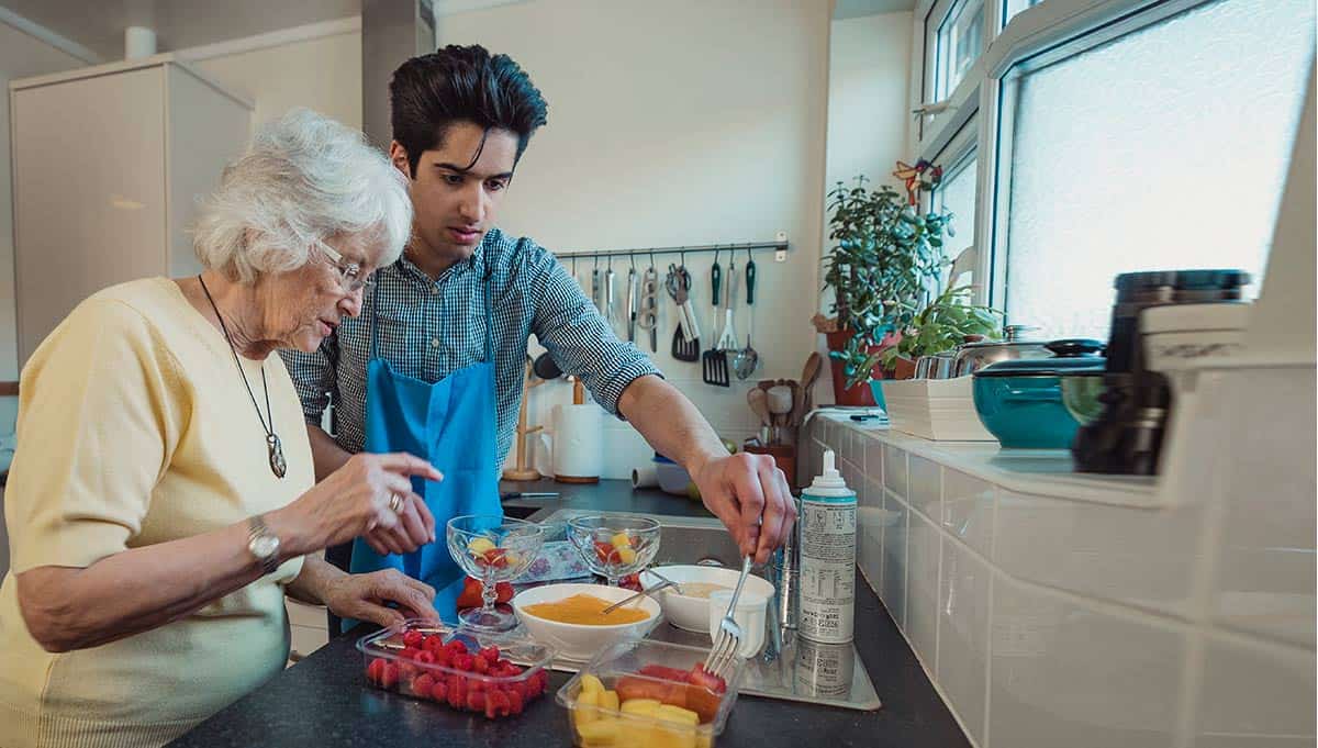 Volunteer cooking with person with Alzheimer's